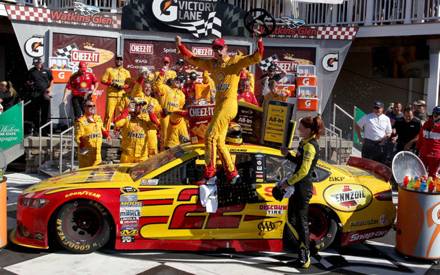 Joey Logano passes Kevin Harvick on the final turn to win at Watkins Glen