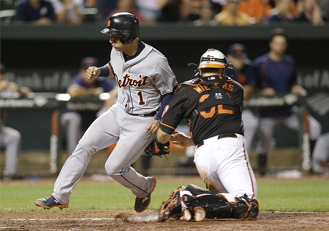 Detroit Tigers&#39 Jose Iglesias is tagged out at home by Baltimore Orioles catcher Matt Wieters on a double by Ian Kinsler in the seventh inning Friday in Baltimore. Baltimore won 8-7