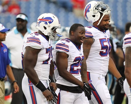 Buffalo Bills linebacker Ikemefuna Enemkpali left running back Le Sean McCoy and Cedric Reed walk on the field before an NFL preseason football game against the Carolina Panthers in Orchard Park