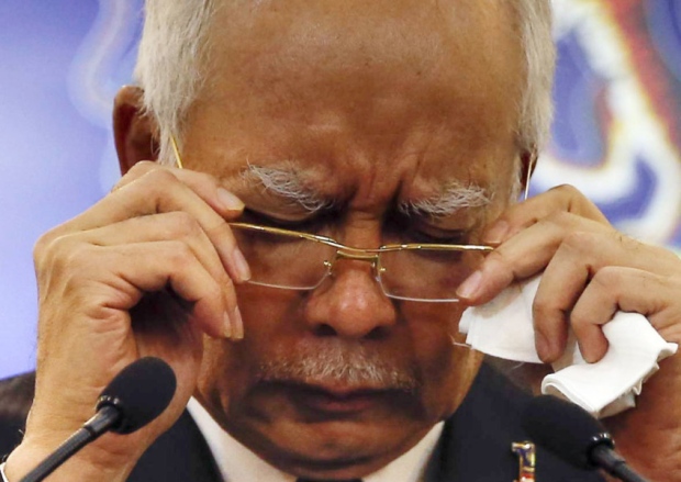 Malaysian Prime Minister Najib Razak gestures before speaking at a special press conference announcing the findings for the ill fated flight MH370 in Kuala Lumpur Malaysia