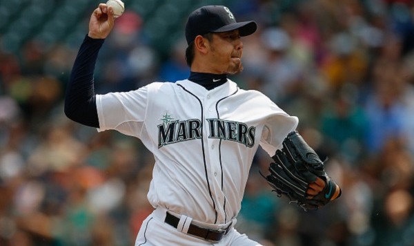 SEATTLE WA- AUGUST 12 Starting pitcher Hisashi Iwakuma #18 of the Seattle Mariners pitches against the Baltimore Orioles in the first inning at Safeco Field