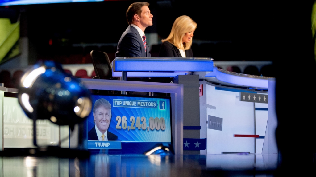 A visual of Donald Trump is shown on screen as Republican presidential candidates are asked his popularity during a pre-debate forum at the Quicken Loans Arena Thursday Aug. 6 2015 in Cleveland. Seven of the candidates have not qualified for the prime