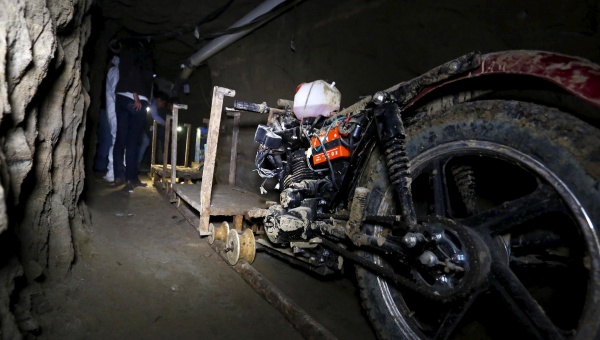 Joaquin'El Chapo Guzman is escorted to a helicopter in handcuffs by Mexican navy marines at a navy hangar in Mexico City on Saturday Feb. 22 2014