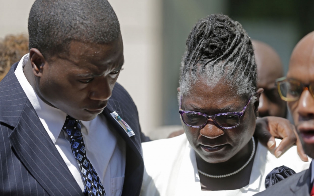 Georgia Ferrell right mother of Jonathan Ferrell is hugged by her son William Ferrell left during a news conference on the first day of the trial of former Charlotte Mecklenburg police Officer Randall Kerrick in Charlotte N.C. Monday