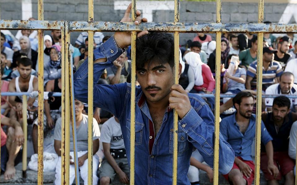 Syrian refugees pack the stands inside the national stadium on the Greek island of Kos Tuesday