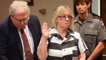 Joyce Mitchell raises her hand during a court appearance in Plattsburgh New York