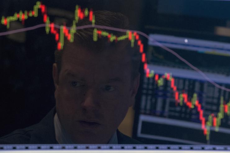 A trader looks on as stocks recover