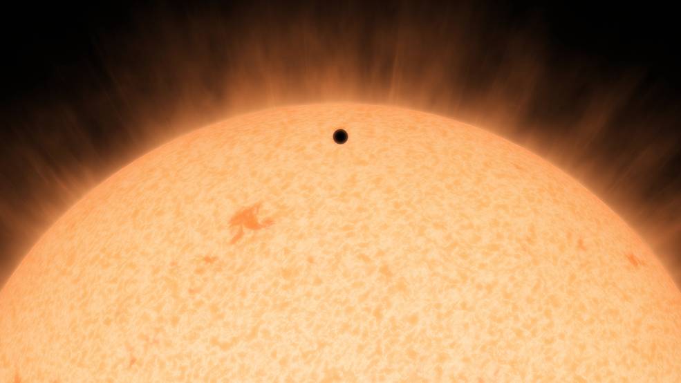 This artist's concept shows the silhouette of a rocky planet dubbed HD 219134b. At 21 light-years away the planet is the closest outside of our solar system that can be seen crossing or transiting its star