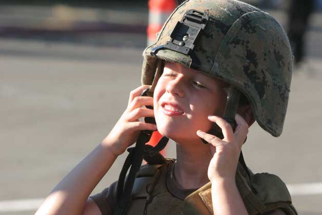 A youngster tries on a helmet during National Night Out on Bainbridge. The Bainbridge Island Police Department will host the event at city hall’s Town Square from 5 to 8 p.m. Tuesday Aug. 4.- Brian Kelly | Bainbridge Island Review