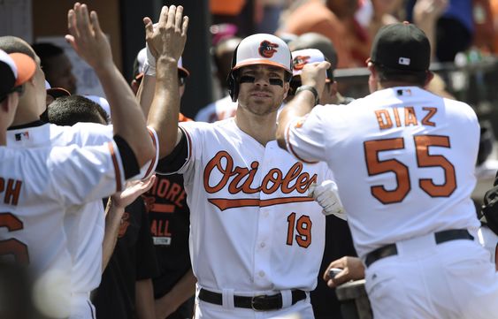 Davis is congratulated in the dugout after hitting a solo home run against the Detroit Tigers during the fourth inning of a baseball game Sunday Aug. 2 2015 in Baltimore