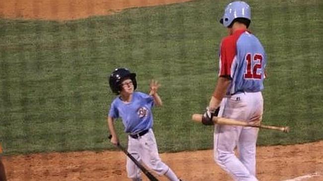 Nine-year-old bat boy Kaiser Carlile on the diamond