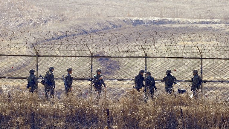 South Korean soldiers checking a military iron fence in the border city of Paju near the demilitarized zone dividing the two Koreas