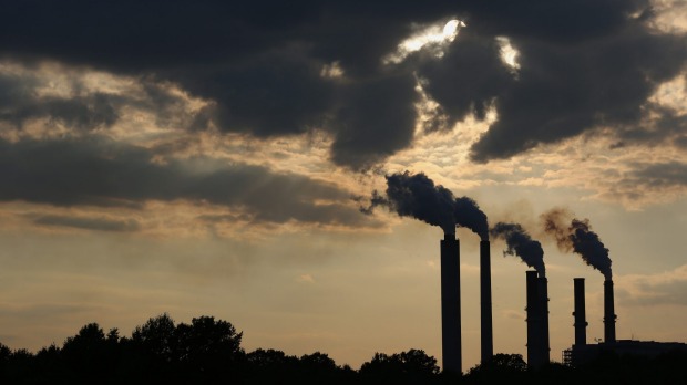 The silhouettes of emissions are seen rising from a power plant in Owensville Indiana on July 23