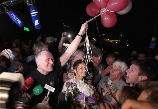 A former opposition presidential candidate Nikolai Statkevich left meets with supporters at a bus station as he was released from a prison Minsk Belarus late