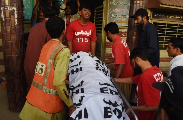 Pakistani volunteers shift Shafqat Hussain's body to a mortuary after his execution in Karachi on Aug. 4 2015