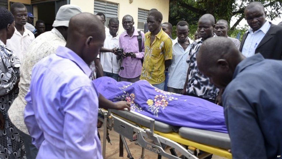 Relatives and other mourners watch as the body of South Sudanese journalist Peter Julius Moi is taken into the mortuary in Juba South Sudan, 20