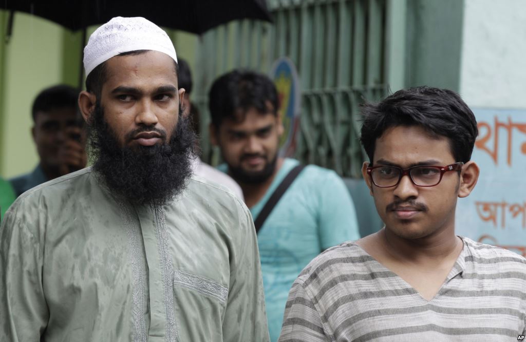 Suspected Muslim militants Saad-al-Nahin right and Masud Rana who were arrested in the last week's killing of a secular blogger stand before the media in Dhaka Bangladesh Friday Aug. 14 2015