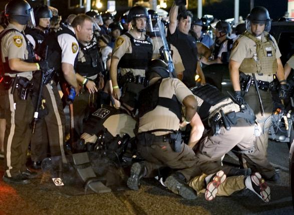 Police detaining a protester in Ferguson Missouri yesterday