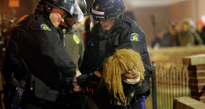 Police officers take a protester into custody Tuesday Nov. 25 2014 in Ferguson Mo