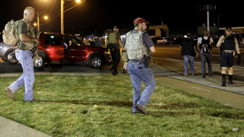 Heavily armed civilians with a group known as the Oath Keepers arrive in Ferguson Mo. early Tuesday Aug. 11 2015. The far-right anti-government activists largely consists of past and present members of the military first responders and police office