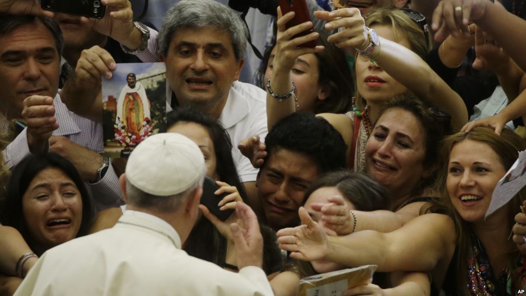 Pope Francis is cheered by faithful as he arrives in the Paul VI hall at the Vatican Aug. 5 2015