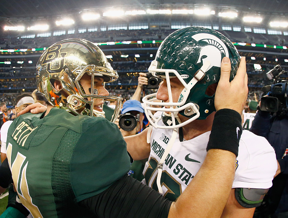 ARLINGTON TX- JANUARY 01 Bryce Petty #14 of the Baylor Bears talks with Connor Cook #18 of the Michigan State Spartans at midfield after the Spartains beat the Bears 42-41 during the Goodyear Cotton Bowl Classic at AT&T Stadium