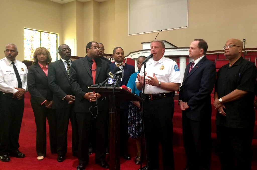 St. Louis police chief Dotson speaks beside clergy and Mayor Francis Slay Thursday in Fountain Park calling for calm after a night of unrest