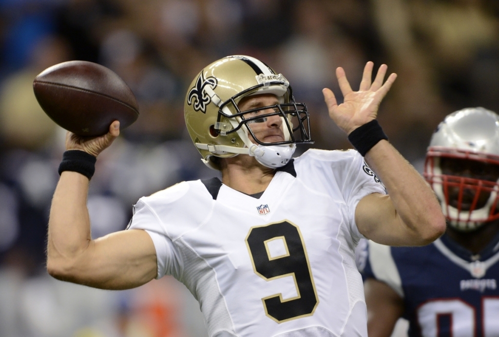 New Orleans Saints quarterback Drew Brees passes in the first half of a preseason NFL football game against the New England Patriots in New Orleans