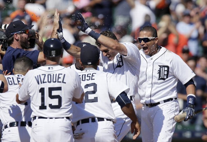 DETROIT MI- AUGUST 6 Ian Kinsler #3 of the Detroit Tigers celebrates with Justin Verlander #35 left Jose Iglesias #1 first base coach Omar Vizquel #15 Anthony Gose #12 and Victor Martinez #41 after hitting a walk-off home run to drive in Iglesias