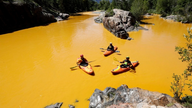 People kayak in the Animas River near Durango Colo. earlier this month in water coloured from a mine waste spill. The U.S. Environmental Protection Agency's critics are seeking to use its handling of the spill to undercut the Obama administration&#3