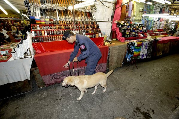 SAKCHAI LALIT							Credit AP				A Thai policeman patrols with a bombsniffing dog in Bangkok