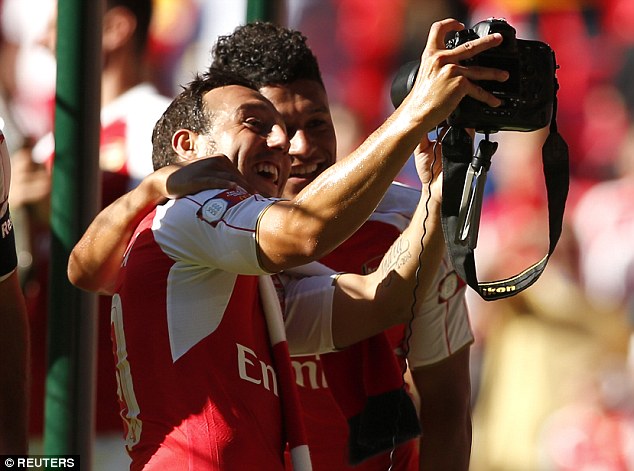 Santi Cazorla and Alex Oxlade Chamberlain take a selfie after their Community Shield win