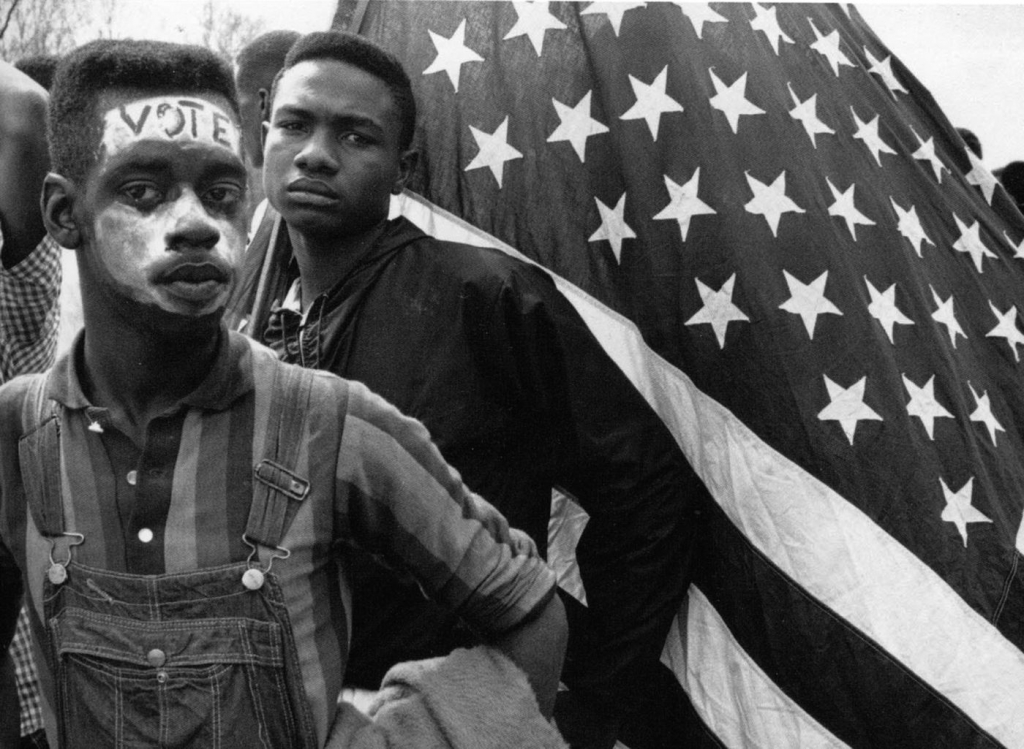 Selma march              
  
           National Archives        Young protestors carry the American Flag in Selma Ala. in 1965