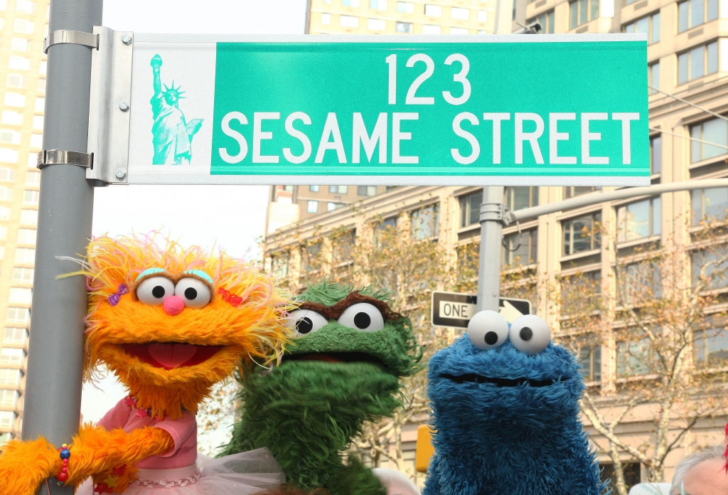 NEW YORK- NOVEMBER 09 Sesame Street characters pose under a'123 Sesame Street sign at the'Sesame Street 40th Anniversary temporary street renaming in Dante Park