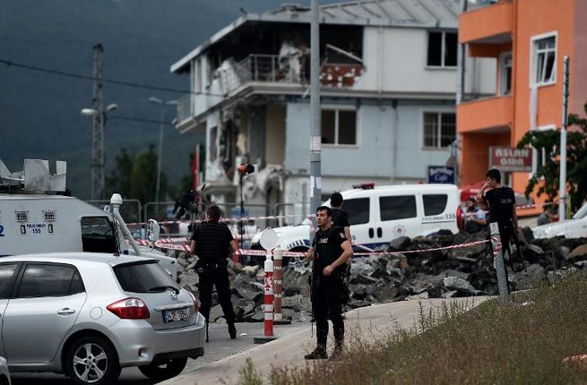 Turkish special forces stand near a damaged police station after it was targeted by a suspected suicide bomber in the Sultanbeyli district in Istanbul