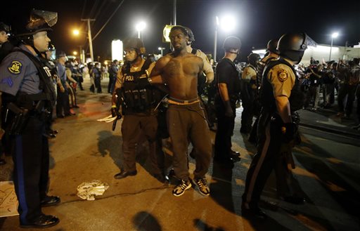 St. Louis County Police make an arrest along West Florissant Avenue Aug. 10 2015 in Ferguson Mo