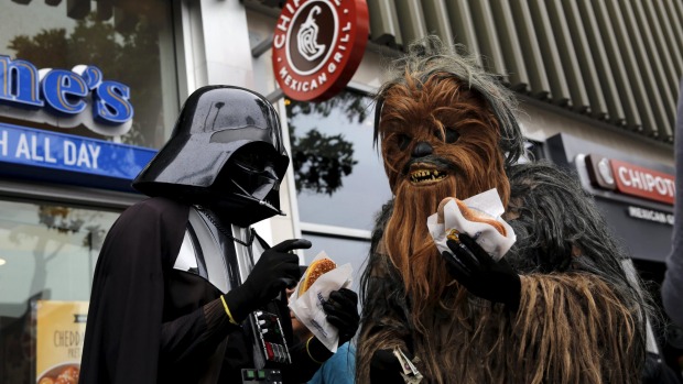 People wearing Star Wars-themed costumes eat pretzels in San Francisco California