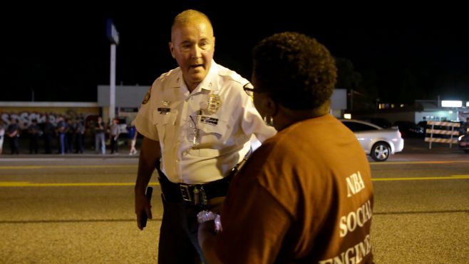 Protesters gather along West Florissant Avenue during a demonstration in Ferguson Mo. Tuesday