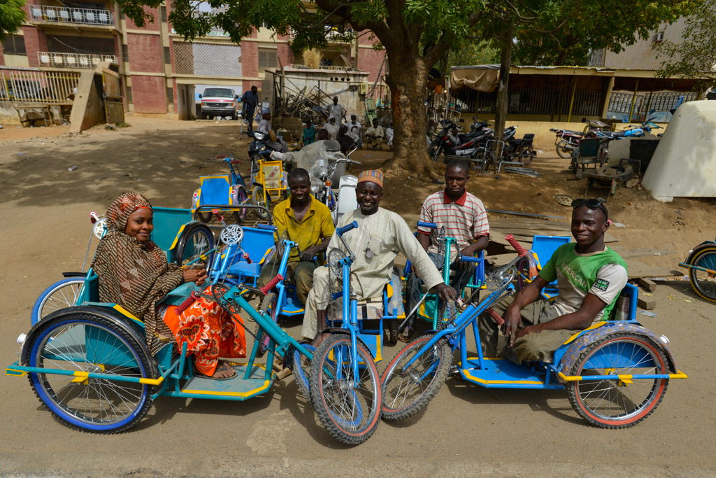 Survivors of polio in Kano State Nigeria sit on tricycles specially designed for people with disabilities