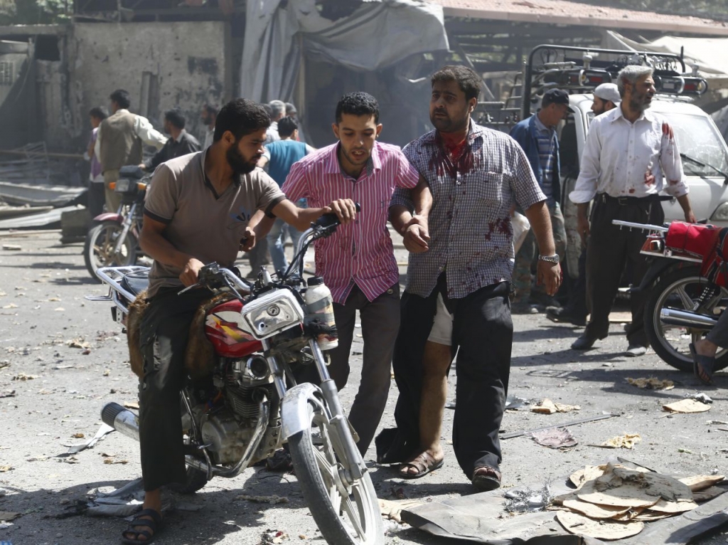 Syrian men react at the scene of reported air strikes by regime forces in the rebel-held Eastern Ghouta area near Damascus today. At least 31 civilians were killed in Syrian government air strikes near Damascus as a barrage of deadly rebel rocket fire hit