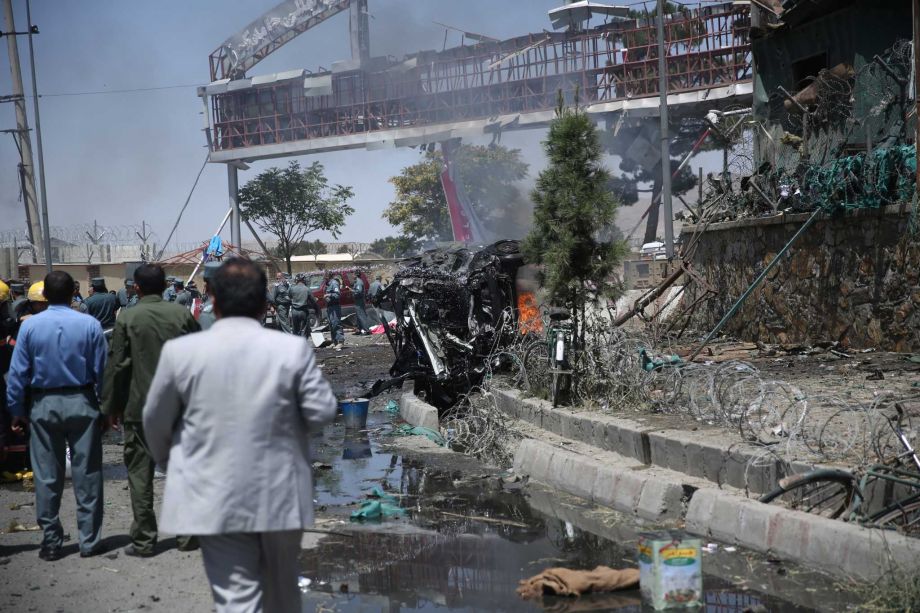 Afghan security forces inspect the site of an attack at the main gate of International Hamed Karzai Airport in Kabul Afghanistan Monday Aug. 10 2015. An explosion on Monday at a busy roundabout near the entrance to Kabul's international airport that