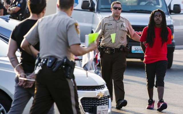 Officers from the St Louis County Police Department process demonstrators from the'Black Lives Matter movement who had been arrested for protesting on Interstate 70 in Earth City Missouri