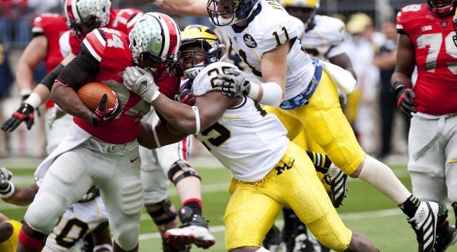 Michigan linebacker Kenny Demens and safety Jordan Kovacs tackle Ohio State running back Carlos Hyde on Saturday. Daniel Brenner I