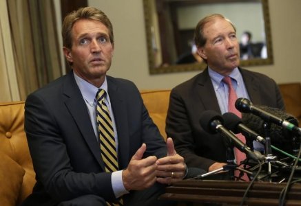 U.S. Republican Senator Jeff Flake speaks to reporters as U.S. Democrat Senator Tom Udall listens during a news conference in Havana