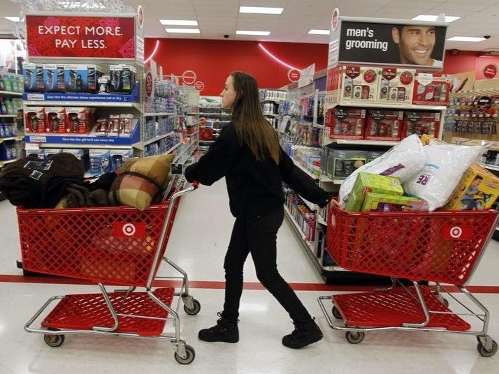 A woman pulls shopping carts through the aisle of a Target store Connecticut