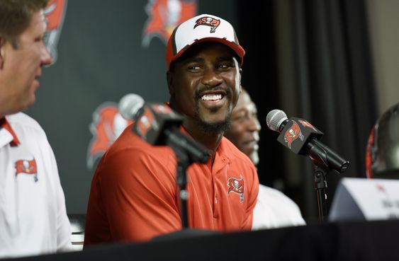 Lavonte David smiles at General Manager Jason Licht during a news conference Monday Aug. 10 2015 in Tampa Fla. Lavonte David and the Buccaneers have agreed to a five-year $50.25 million contract extension that will make