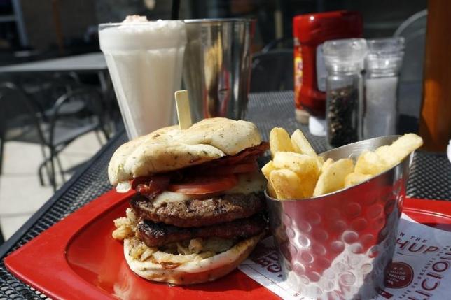 A meal of a ''Monster'&#039-sized A.1. Peppercorn burger Bottomless Steak Fries and Monster Salted Caramel Milkshake is seen at a restaurant in Foxboro Massachusetts