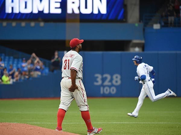 Philadelphia Phillies pitcher Jerome Williams prepares for his next pitch as Toronto Blue Jays shortstop Troy Tulowitzki rounds the bases after hitting a two-run home run in the third inning at Rogers Centre