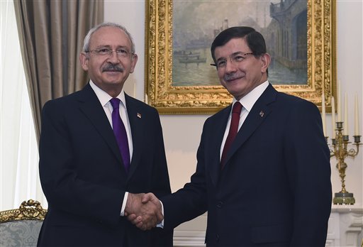 Turkish Prime Minister and leader of Justice and Development Party Ahmet Davutoglu right shakes hands with the leader of the main opposition Republican People's Party Kemal Kilicdaroglu left prior to their meeting regarding possible coalit