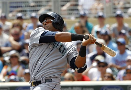 Seattle Mariners right fielder Nelson Cruz follows through on a single to center field off Minnesota Twins starting pitcher Mike Pelfrey during the first inning of a baseball game in Minneapolis Sunday Aug. 2 2015